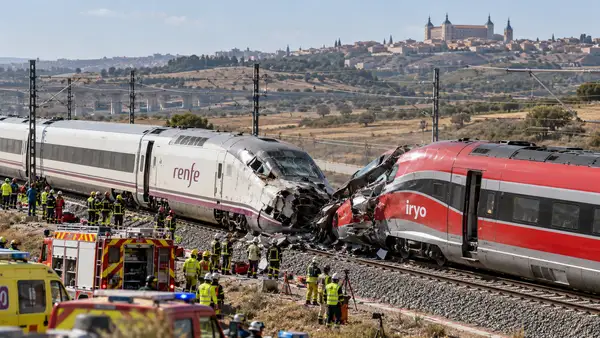 Illustration de deux trains à grande vitesse aux couleurs de Renfe et d’Iryo, arrêtés sur des voies parallèles, avec un agent près d’un équipement de signalisation. Cette scène générée accompagne l’article sur la collision près de Tolède et ne représente pas le lieu de l’accident.