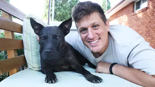 Paul Conyngham, entrepreneur en IA, aux côtés de sa chienne Rosie, symbolisant l'innovation et l'espoir d'un vaccin personnalisé.